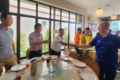 Ka Siong (kanan) beramah mesra dengan pengundi di Bandar Chukai pada Ahad.