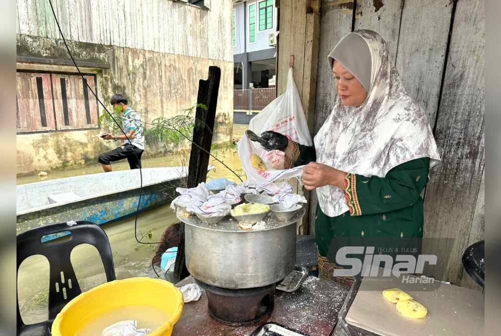 Azizah menyiapkan putu halba yang ditempah pelanggan.