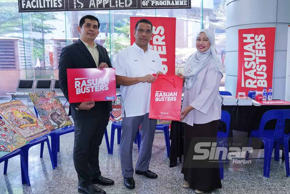 Pegawai Perhubungan Strategik Rasuah Busters, Wan Normi Hasan (kanan) menyampaikan cenderahati kepada Azhar pada Majlis Perasmian Sambutan Hari Anti Rasuah Antarabangsa (HARA) 2023 di UniKL Kampus Kota pada Isnin. Foto Sinar Harian / MOHD HALIM ABDUL WAHID