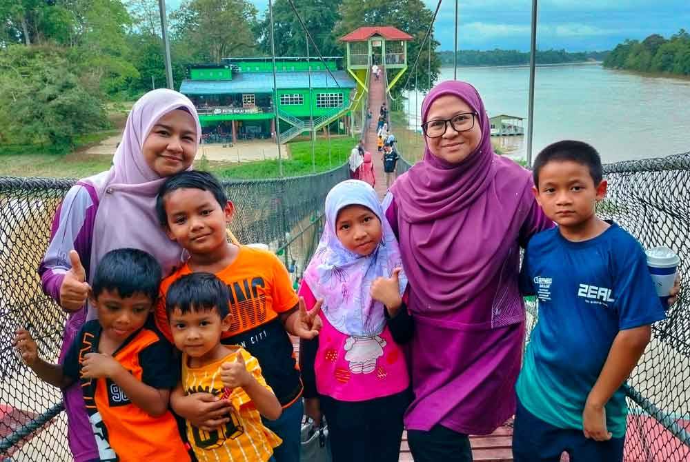 Nur Farihah (dua dari kanan) dan Siti Nurulhidayu (kiri) bersama anak mereka.
