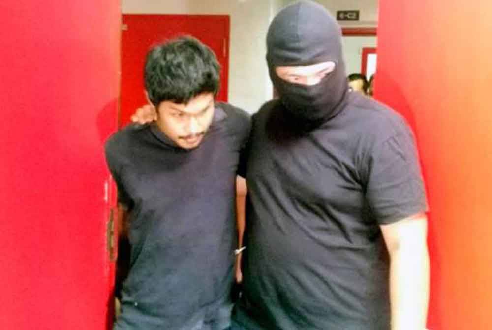 Mahadi (kiri) sewaktu diiringi polis dari Bahagian Antipengganas (E8) di Mahkamah Sesyen Kuala Terengganu pada 2019 lalu. -Foto fail Sinar Harian