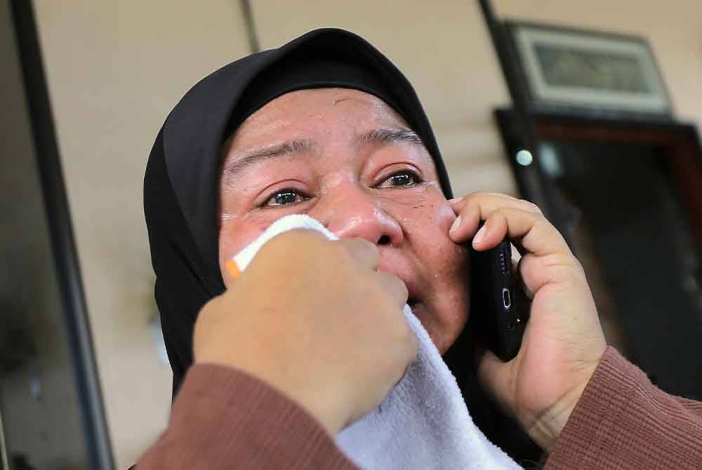 Mimi Julia ismail, 50 kelihatan sedih ketika ditemui di kediaman keluarganya di Taman Chepor Sentosa Chemor pada Sabtu. - Foto: Bernama