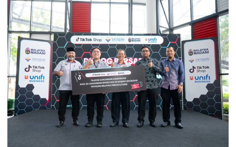 (Dari kiri), Gulam Muszaffar, Mun Wei Siew, Zahir, Muhammad Fikri dan Mohamad bergambar sambil menunjukkan inisiatif sokongan kewangan usahawan mikro B40 di bawah kerjasama TikTok Shop dengan YWP.