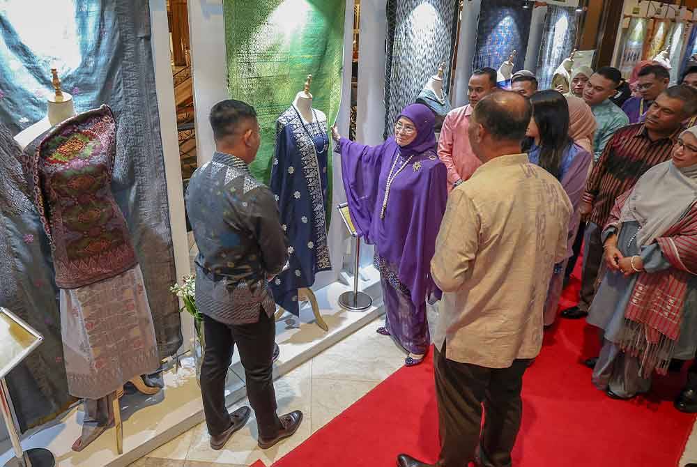 Tunku Azizah berkenan melawat pemerah songket hasil tenunan penghuni penjara semasa majlis Malam Simfoni Kasih 2023 Jabatan Penjara Malaysia di sini malam ini. - Foto Bernama