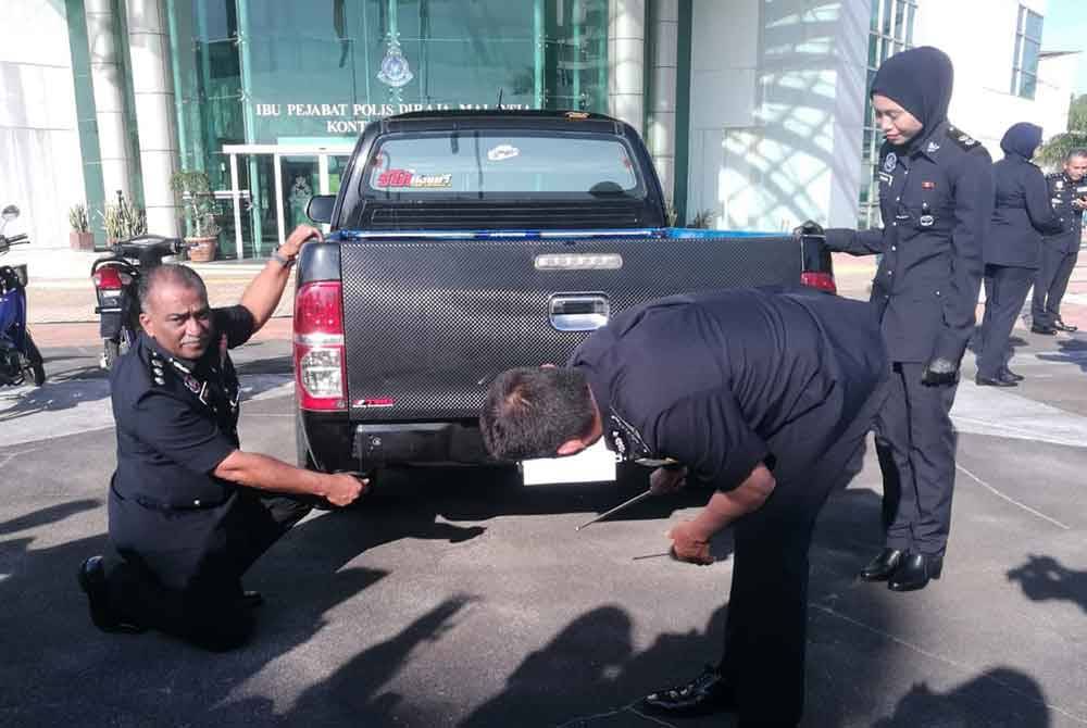 Fisol (kanan) menunjukkan bahagian bawah kenderaan tersebut yang menempatkan tayar ganti berisi 10 kilogram syabu.