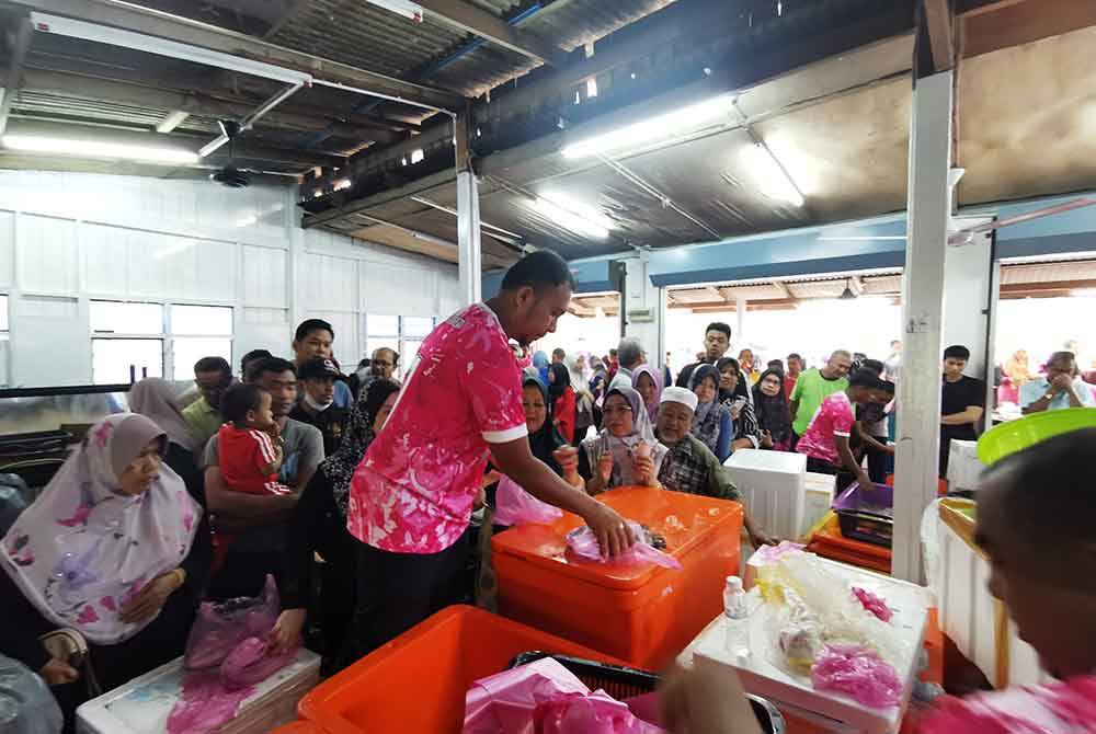 Sauffian (tengah) tidak menang tangan melayan pelanggan yang menyerbu premisnya sempena pembukaan cawangan keempat Ikan Flyover di Kuala Ibai, Kuala Terengganu.