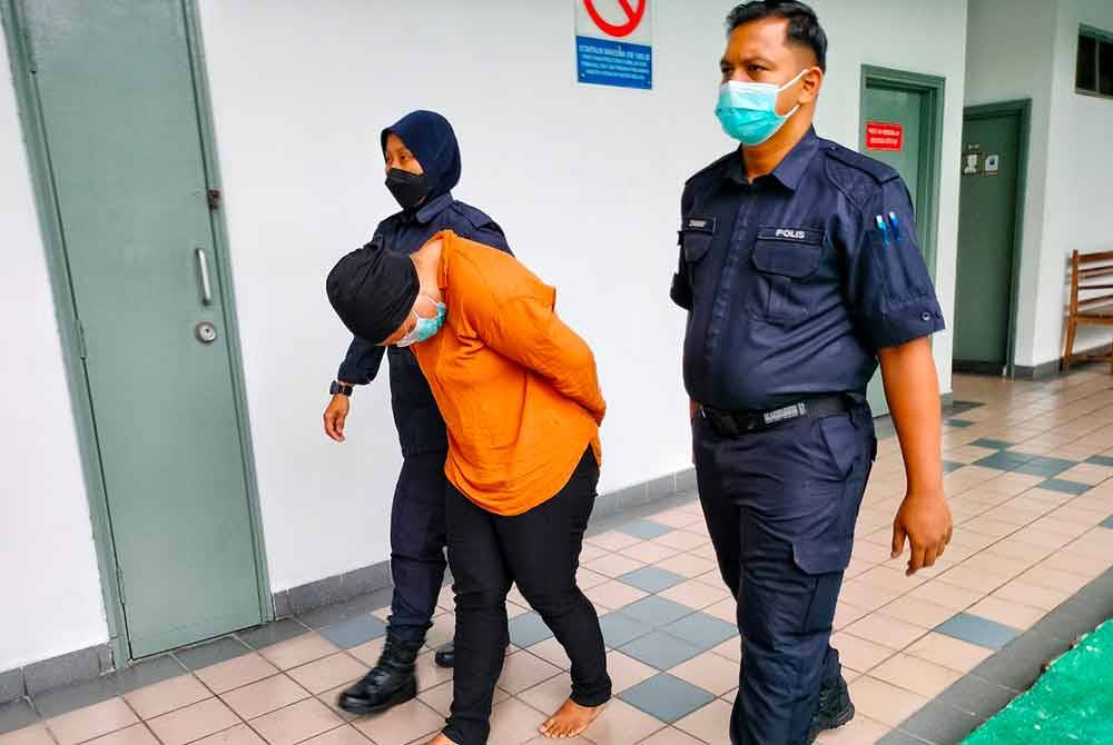 Zami Nor Aida (tengah) ketika dibawa keluar dari Mahkamah Majistret di sini, pada Selasa.