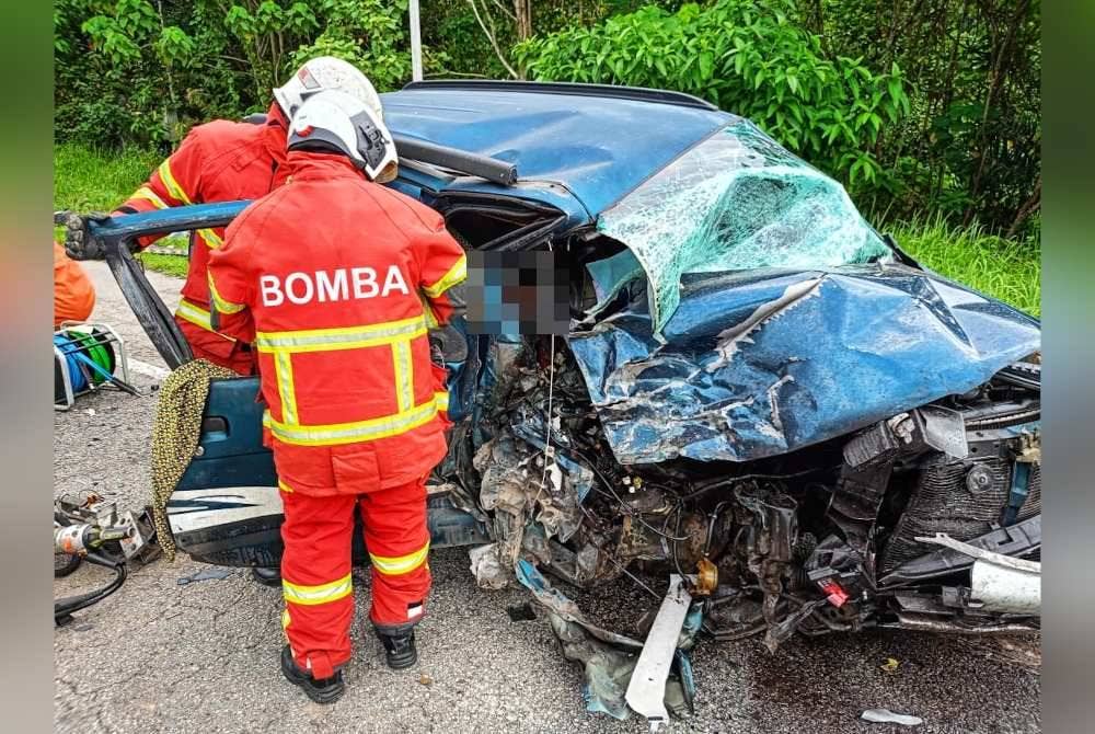 Anggota bomba mengeluarkan mangsa yang tersepit dalam Kembara. Foto Ihsan JBPM