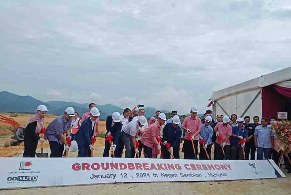 Aminuddin (enam dari kiri) ketika melakukan simbolik pecah tanah pada Majlis Pecah Tanah Pembinaan Kilang Automatif Pemasangan Kenderaan EV Careplus di Rembau pada Jumaat.