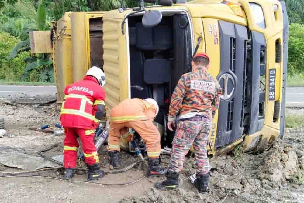 Anggota bomba menjalankan operasi mengeluarkan mangsa tersepit di bahagian pemandu lori sampah.