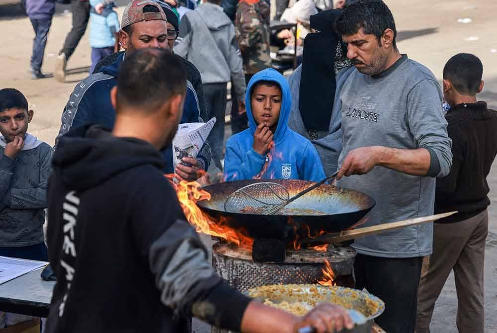 Penduduk menyediakan makanan di Rafah di selatan Semenanjung Gaza. Foto AFP