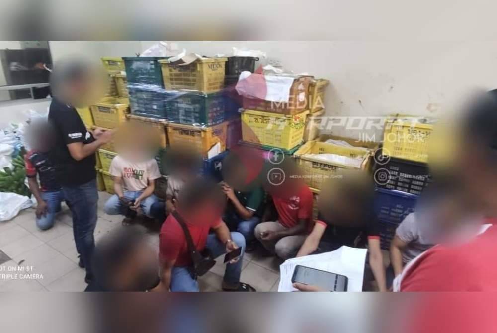 Sebahagian pekerja warga asing yang ditahan dalam serbuan tersebut.