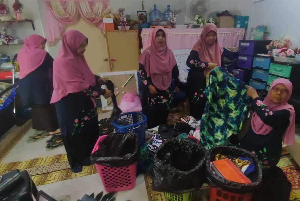 Sukarelawan Pertubuhan Rumah Amal Bakti sedang memilih dan mengasingkan pakaian mengikut saiz di pusat pengumpulan bersebelahan Masjid Sultanah Bahiyah.
