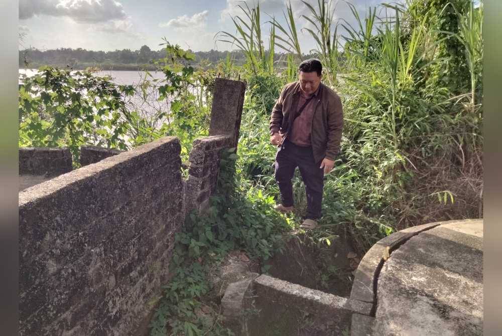 Penduduk melihat retakan pagar sebuah rumah di Taman Haji Hadi.