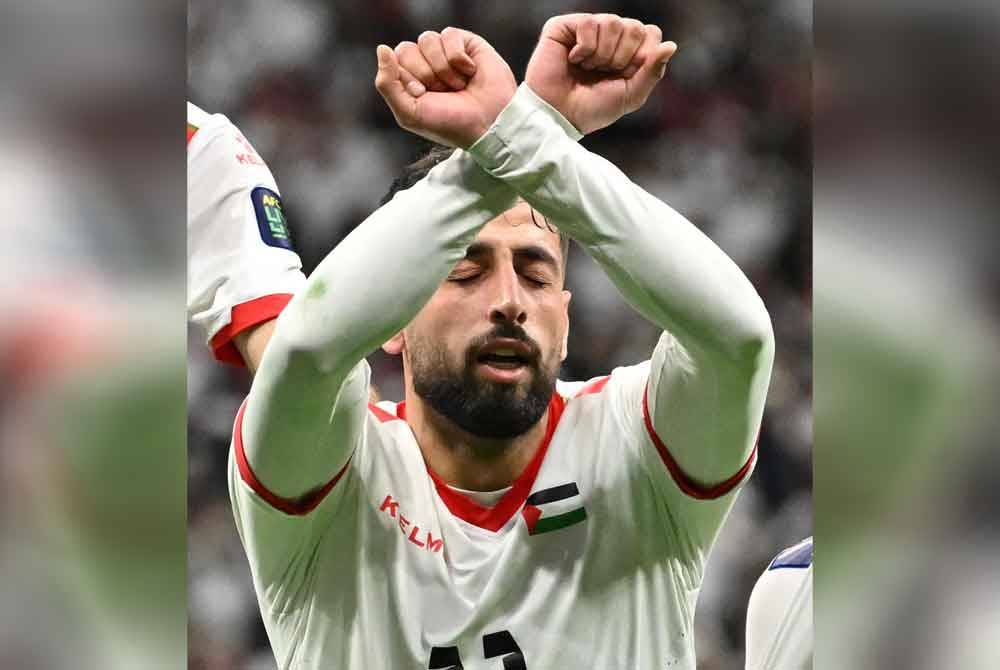 Oday meraikan jaringannya dengan menyilangkan tangan dalam isyarat gari untuk melambangkan nasib rakyat Palestin. Foto AFP