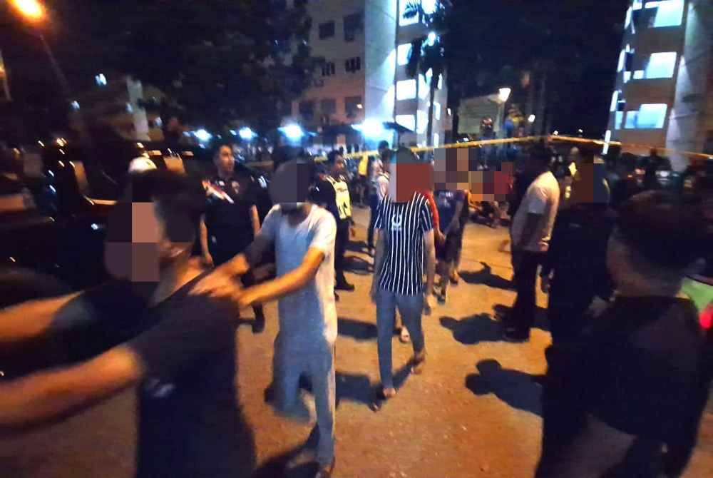 Antara warga asing yang ditahan dalam serbuan di Pangsapuri Aman Perdana, Klang, Selangor pada Khamis.