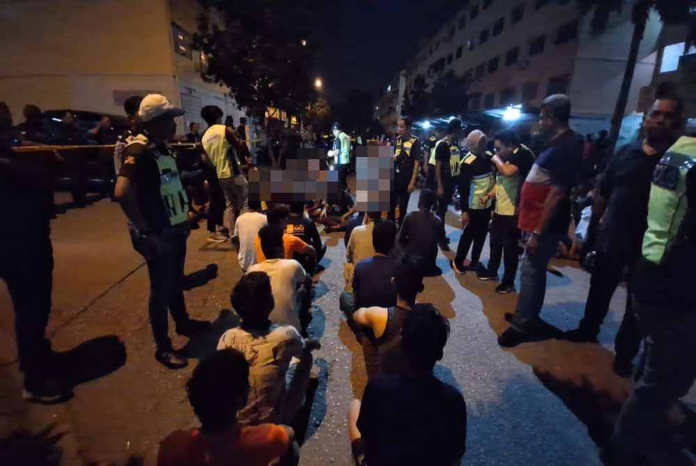 Antara warga asing yang ditahan dalam serbuan di Pangsapuri Aman Perdana, Klang, Selangor pada Khamis.