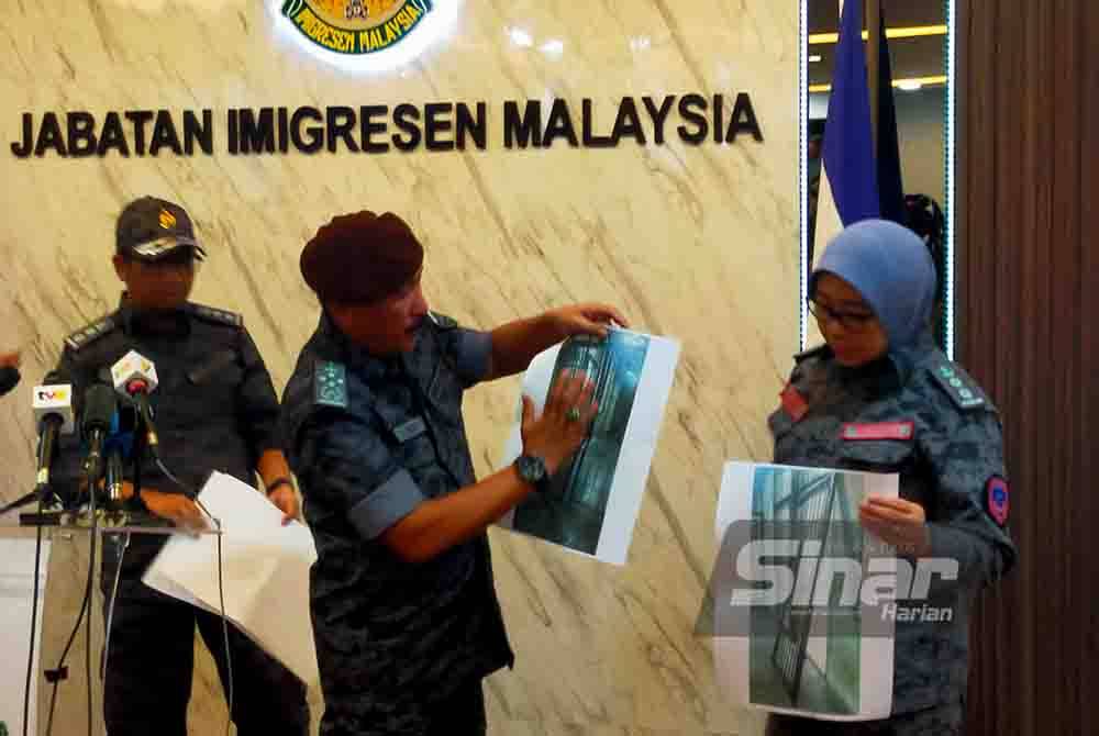 Ruslin (tengah) menunjukkan gambar jeriji besi yang dirempuh sekumpulan tahanan di Depot Imigresen Bidor, Perak pada sidang media, Jumaat. Foto Sinar Harian - HISYAMUDDIN AYUB