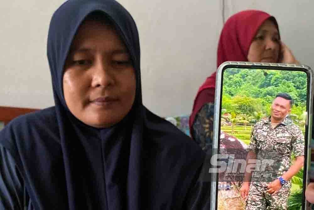 Nor Fatihah menunjukkan gambar Allahyarham suaminya yang akan menjadi pengubat rindu.