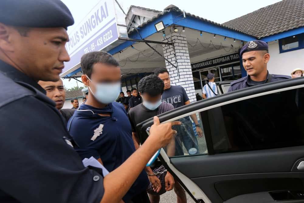 Dua tahanan lolos dari Depot Sementara Imigresen Bidor ditahan sedang berjalan kaki di dalam kebun sawit Felda Sungai Klah, Sungkai di sini tengah hari Isnin. Foto Bernama