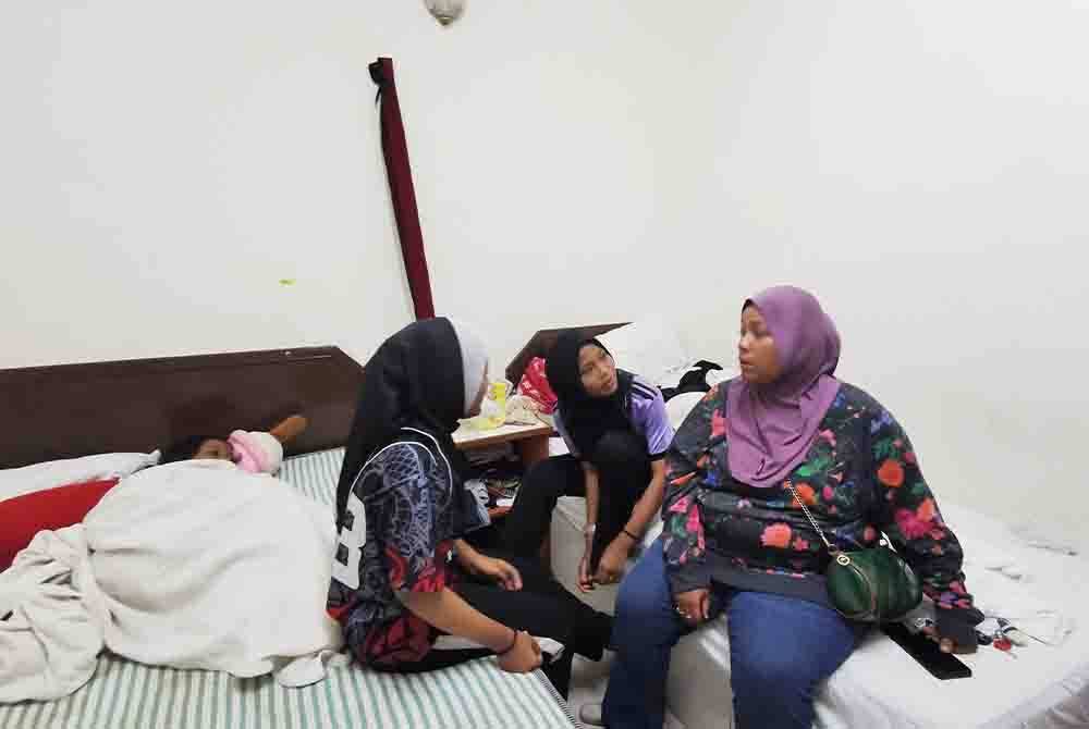 Izawati (kanan) bersama anak-anaknya ketika ditemui di bilik hotel di bandar Kuala Terengganu.