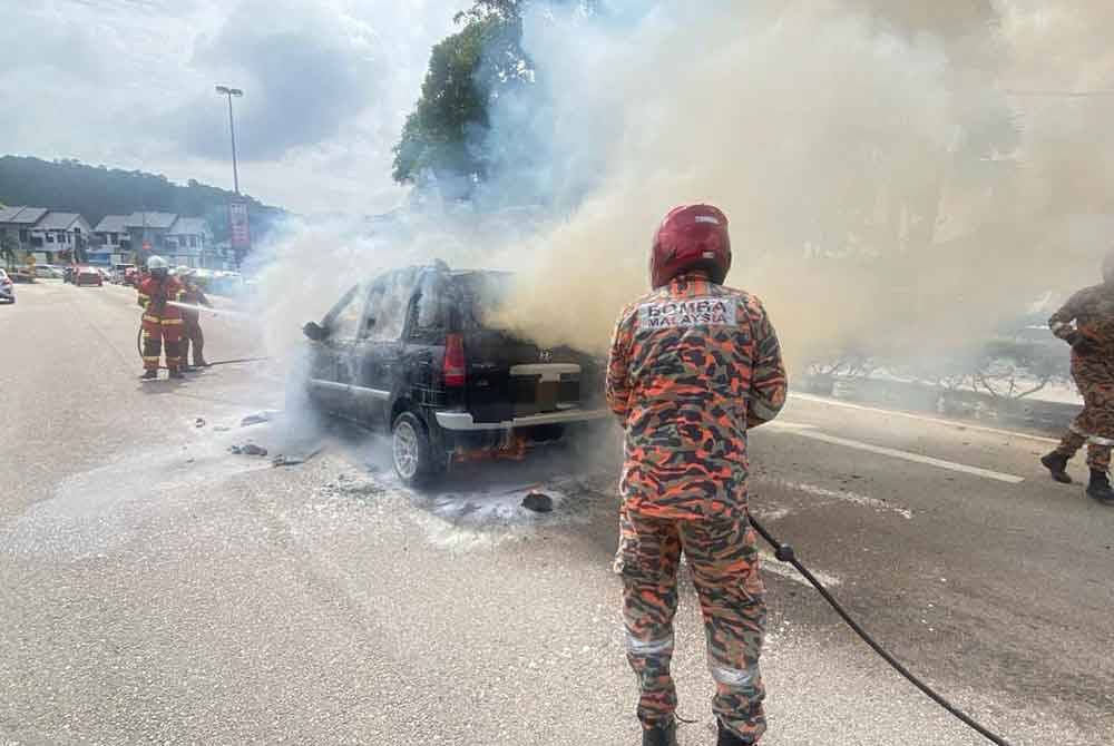 Anggota bomba memadamkan kebakaran kereta. - Foto BBP Penggaram