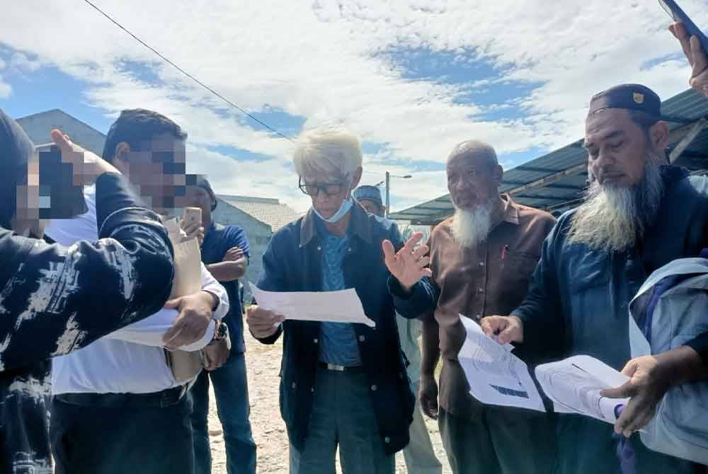 Penduduk membantah kerja meroboh dan mahu tapak Surau Al-Karamah, Kampung Seri Keramat dikekalkan.