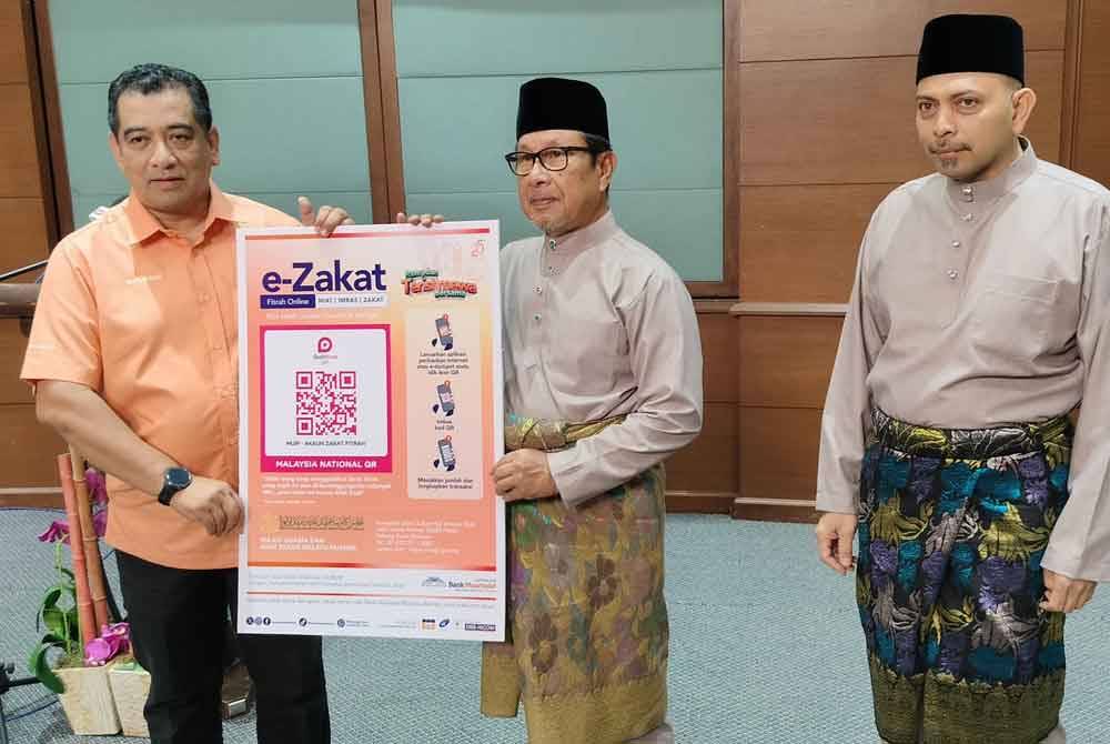 Ahmad Hairi (tengah) menunjukkan kod QR yang disediakan bagi memudahkan umat Islam di negeri ini membayar zakat fitrah.
