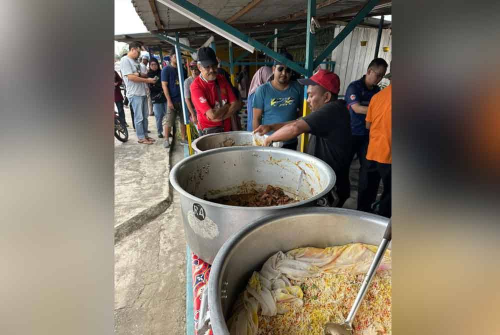Orang ramai beratur membeli nasi beriani gam Hasan di bazar Ramadan Pekan Parit Betak.