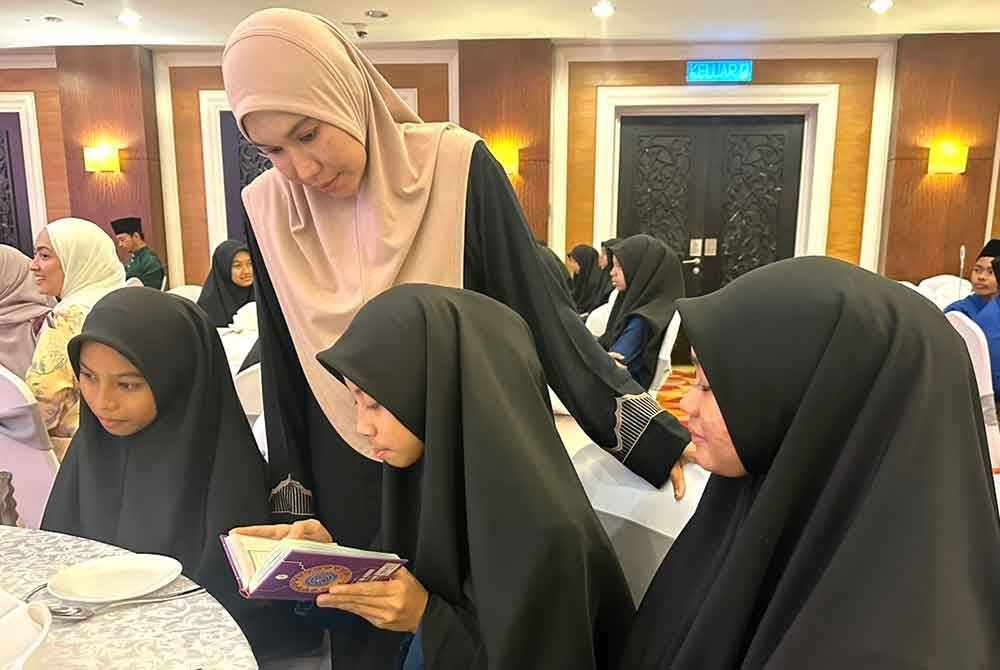 Rusma Qasrina (dua dari kanan) membaca al-Quran.