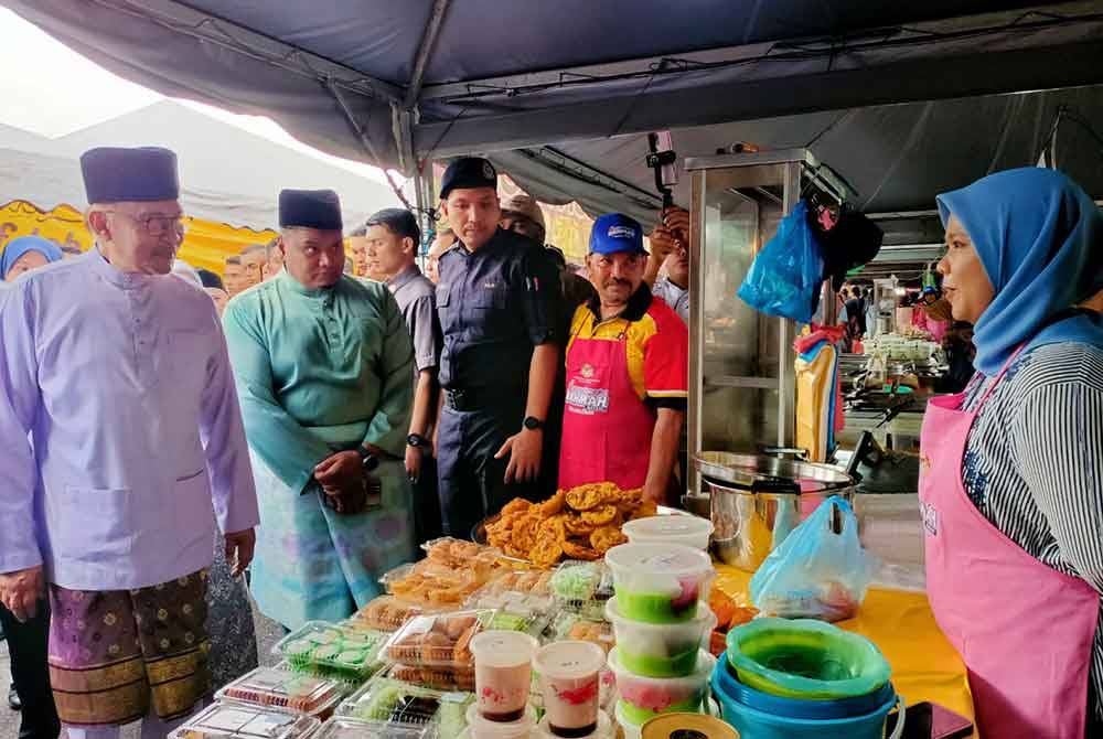 Anwar membeli kuih-muih dan lauk antaranya cucur udang, nasi lemak, nasi ayam berempah dan sate.