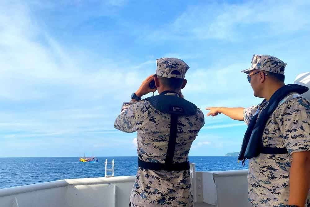 Amiludin (kanan) memantau anggota yang melakukan penugasan di perairan Kelantan.