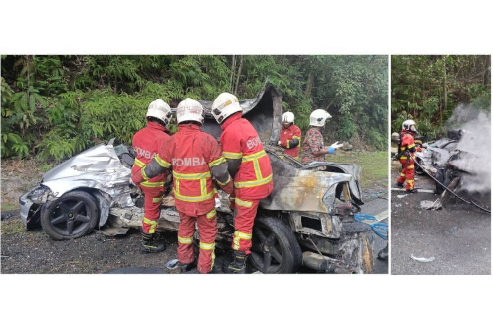 Pasukan bomba dan penyelamat memadam api pada kereta mangsa. Anggota bomba cuba mengeluarkan mayat mangsa yang tersepit dalam nahas membabitkan BMW dan lori di Jalan Seremban-Mantin dekat Bukit Mantin pada Isnin. Foto Bomba