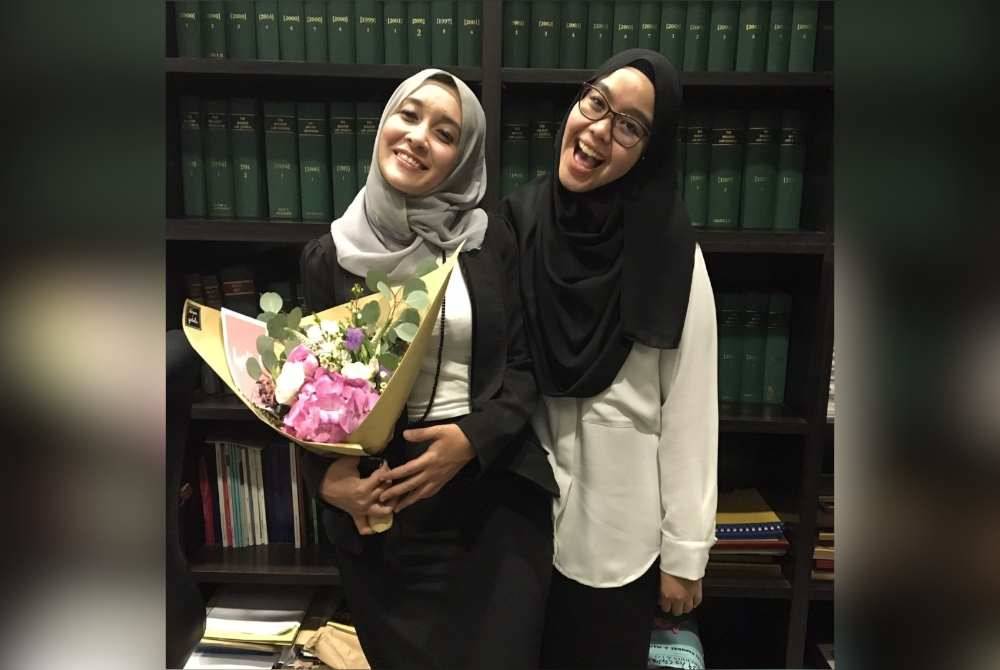 Puteri Ummi Kartini (kiri) menerima penghargaan daripada rakan sekerja selepas menang satu kes rayuan.