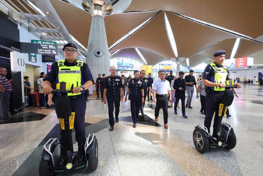 Amiruddin (kanan) bersama Timbalan Ketua Polis Selangor Datuk S Sasikala Devi (dua dari kiri), diiringi anggota PDRM yang menggunakan E-Scooter pada Majlis Penyerahan Sumbangan Penajaan Kenderaan Mikromobiliti E-Scooter kepada PDRM Kontinjen Selangor di KLIA Terminal 1 pada Rabu. Foto Bernama
