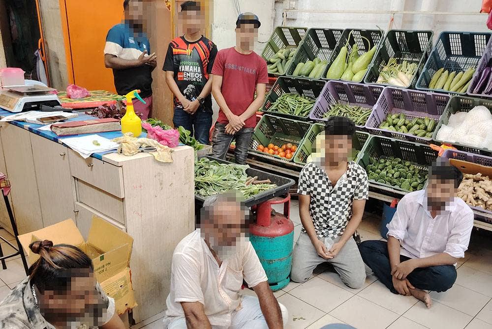 Antara warga asing yang diperiksa di premis perniagaan sekitar Jalan Abraham, Kuala Lumpur pada Jumaat.