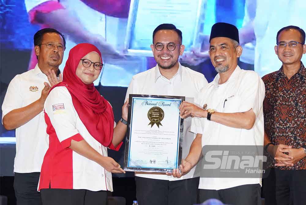 Wakil Malaysia Book of Record, Siti Hajar Johor menyampaikan sijil kepada Ketua Pengarah Jabatan Keselamatan dan Kesihatan Pekerjaan Malaysia, Mohd Hatta Zakaria disaksikan oleh Steven pada Majlis Sambutan Hari Sedunia Bagi Keselamatan dan Kesihatan Di Tempat Kerja 2024 pada Ahad. Foto Sinar Harian-ROSLI TALIB