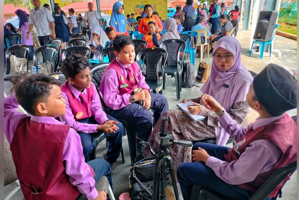 Guru dan murid Sekolah Renda Arab (SRA) JAIM Batang Tiga berbincang sebelum menghasilkan bahan video.