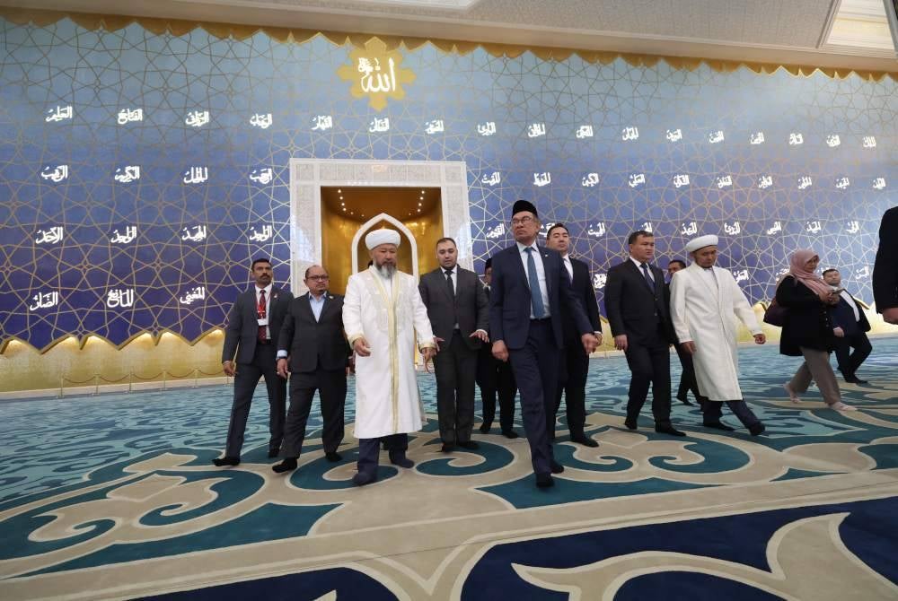 Anwar diberi taklimat oleh Ketua Mufti, Nauryzbai Taganuly Optenov (tiga, kiri) yang juga Pengerusi Pentadbiran Kerohanian Umat Islam Kazakhstan (MUFTYAT) semasa melawat Masjid Besar Astana. Foto Bernama