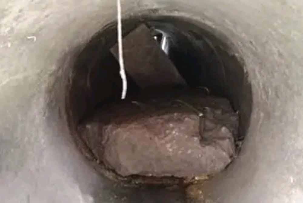 Batu konkrit yang menghalang pergerakan air yang dikesan terdapat di longkang di Jalan Bendahara 14 di sini pada Khamis.