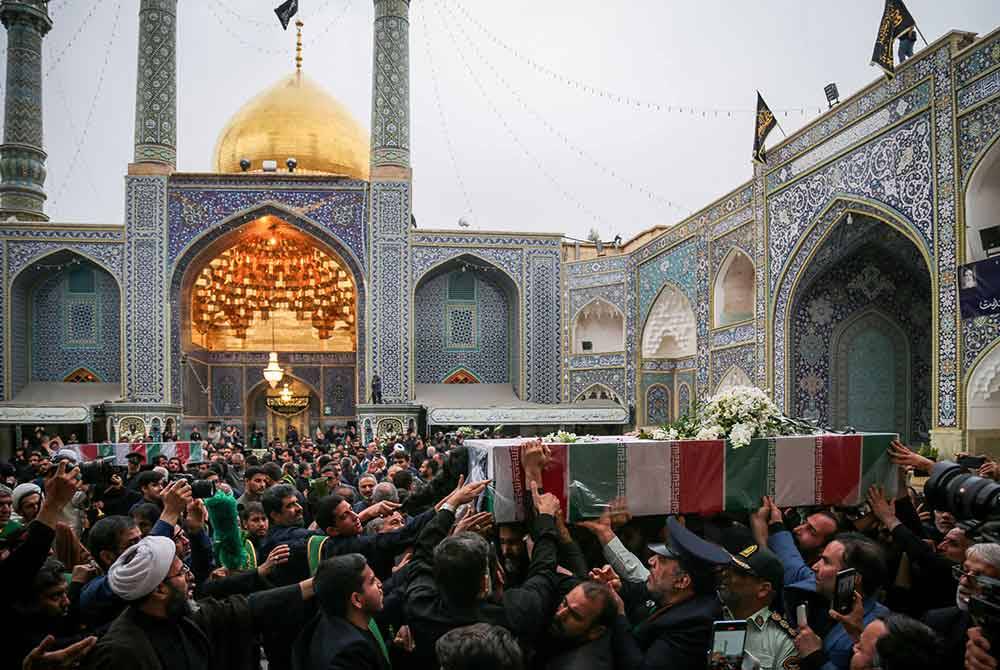 Keranda Ebrahim Raisi diiringi ribuan penyokong semasa diarak sebelum dikebumikan di Kubah Emas Imam Reza. Foto AFP