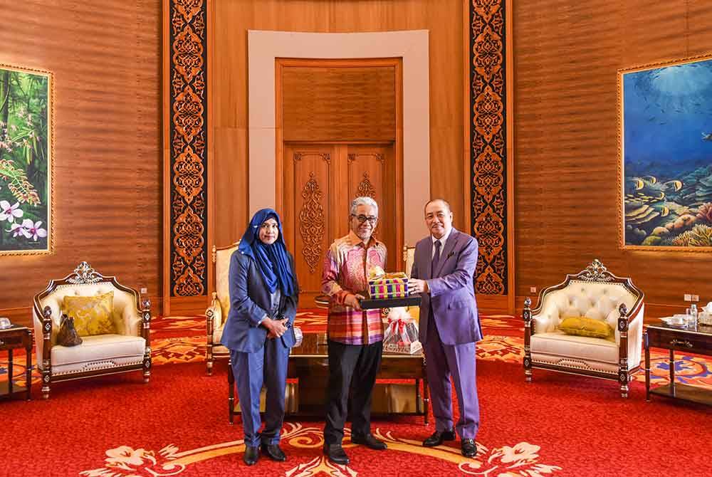 Tengku Ahmad Badli Shah (tengah) menyerahkan cederahati ketika kunjungan hormat ke pejabat Menteri Sabah baru-baru ini.