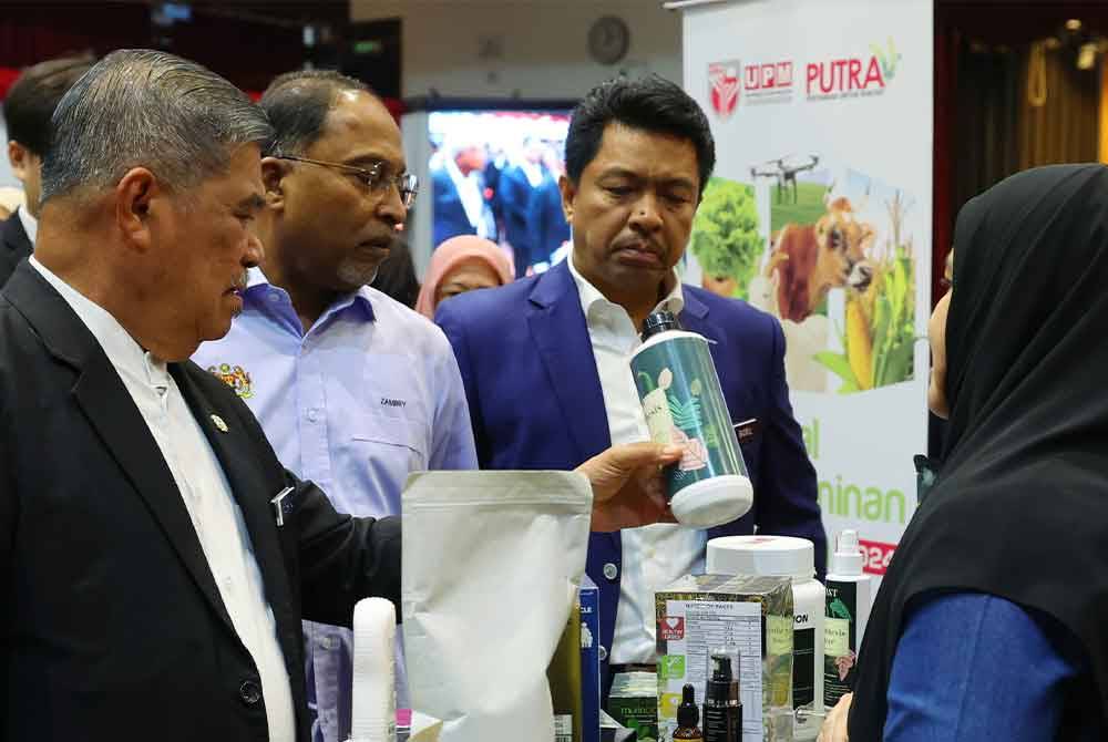 Mohamad (kiri) bersama Dr Zambry (dua, kiri) melawat ruang pameran dan jualan pada Majlis Pelancaran Blueprint Keterjaminan Makanan UPM di UPM pada Jumaat. Foto Bernama