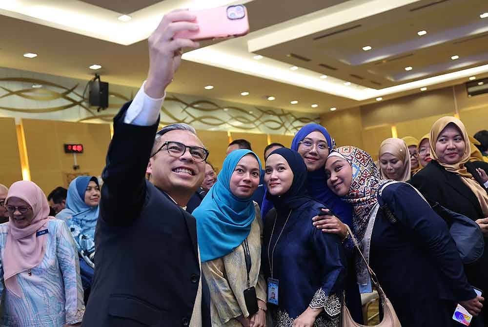 Fahmi berswafoto bersama sebahagian kakitangan Kementerian Komunikasi selepas Majlis Perhimpunan Bulanan Kementerian Komunikasi di Kompleks Kementerian Komunikasi pada Selasa. Foto Bernama