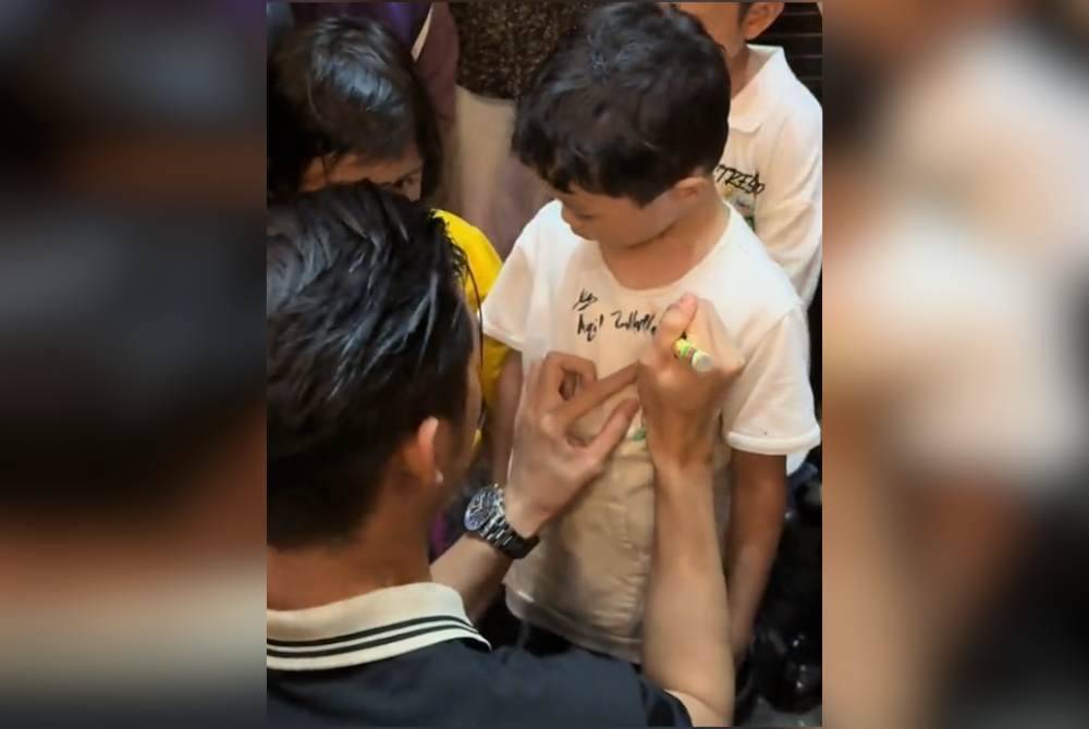 Aqil melayan kerenah peminat ciliknya.
