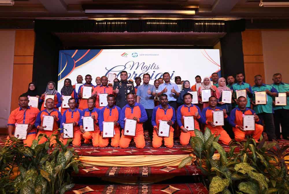 Ahmad Husaini (berdiri, tengah) bersama penerima Anugerah Pekerja Cemerlang ketika majlis meraikan Hari Pekerja Pembersihan 2024 di Negeri Sembilan.