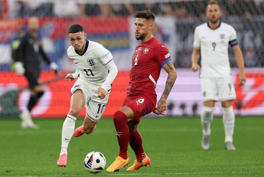 Foden (kiri) berusaha melepasi pemain tengah Serbia, Nemanja Gudelj semasa perlawanan Kumpulan C Euro 2024 di Arena AufSchalke, Gelsenkirchen.