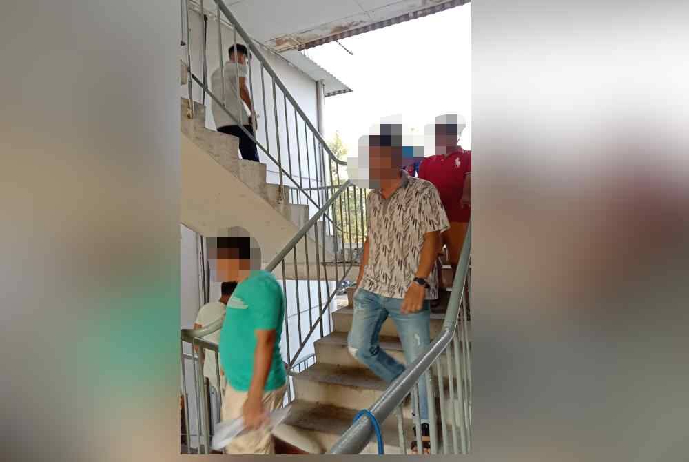 Antara warga asing yang ditahan untuk pemeriksaan dalam operasi di perumahan flat Jalan Sultan Abdul Samad di Bandar Sultan Suleiman pada Ahad.
