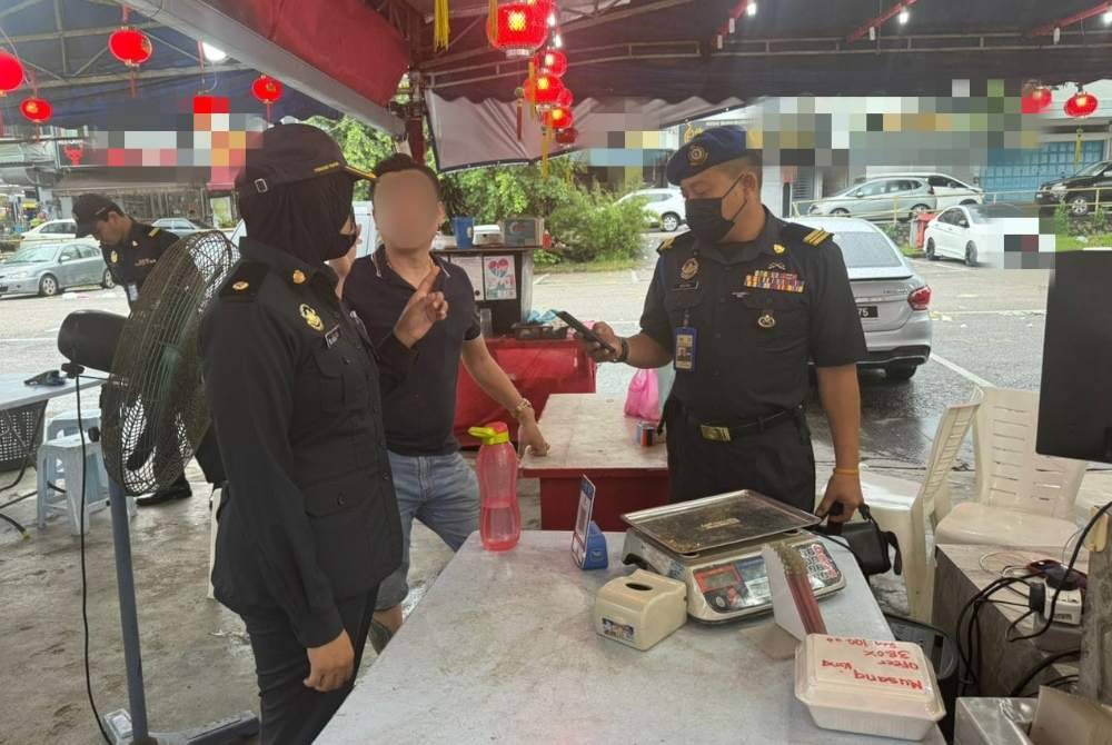 Anggota KPDN Johor melakukan pemeriksaan di sebuah premis menjual durian di Johor Jaya pada Ahad.
