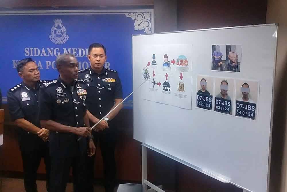 Kumar (tengah) menunjukkan carta aliaran sindiket pengemis OKU warga asing dalam sidang akhbar di Ibu Pejabat Polis Kontinjen (IPK) Johor pada Selasa.